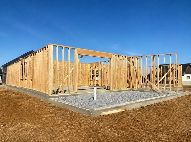 New home under construction with foundation in place